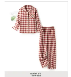 Close-up of women's red plaid cotton pajama set with cute bear embroidery on pocket