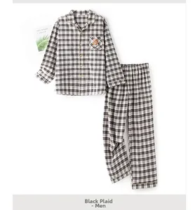 Detail of men's black grid pajama set featuring a cute cartoon brown bear embroidery