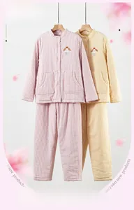 Detail of warm three-layer padded pajama set featuring pink plaid fabric and embroidery