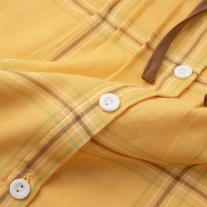 Cotton plaid pajama set with yellow grid pattern showing fabric texture and buttons
