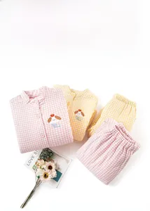 Detail of warm three-layer thermal cotton pajamas with cute animal embroidery and plaid pattern