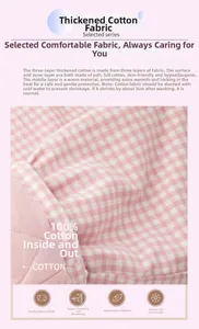 Detailed close-up of three-layer quilted cotton fabric with pink gingham check pattern