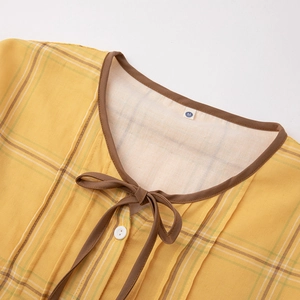 Women's yellow plaid cotton pajama top with round neckline and decorative bow detail