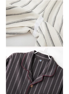 Detailed view of striped cotton pajamas featuring a wood button and red piping accents