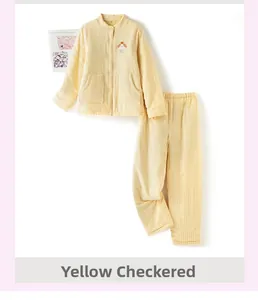 Detail of yellow plaid quilted pajamas showing a cute animal embroidery and buttons