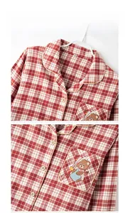Detail of red checkered cotton pajama set with a cute cartoon bear embroidery on pocket