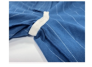Close-up of reinforced seam and white stripes on navy blue cotton pajama pants
