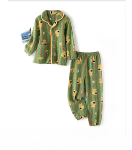 Detail of green quilted cotton pajamas set featuring cute animal embroidery and stripes