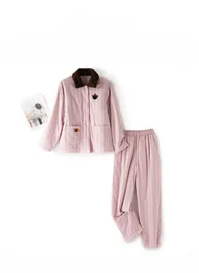 Detail of pink striped quilted pajama set with feline embroidery and plush collar