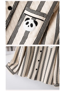 Detail of quilted pajama top with vertical stripes and cute panda embroidery pocket