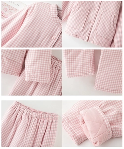 Detail view of pink plaid quilted thermal pajamas showing stitching, pockets, and elastic waist
