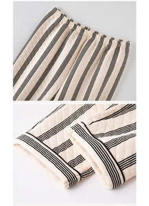 Detail of striped quilted pants showing elastic waistband and stitched cuff texture