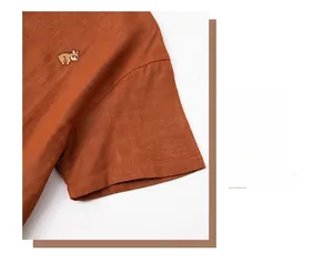 Close-up of brick red cotton pajamas featuring exquisite cartoon dog embroidery and fine stitching