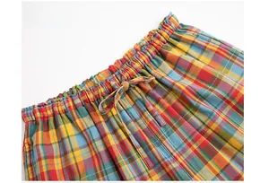 Detail of colorful plaid cotton pajama shorts featuring elastic waistband and drawstring cord