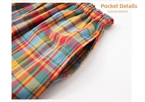 Detail of multi-color plaid pants featuring elastic waistband and functional side pockets