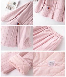Detail of pink striped quilted cotton sleepwear showing fabric texture and embroidery