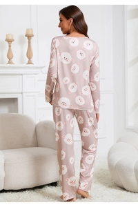 Rear view of a model wearing sweet cartoon sheep print pajamas in a modern living room decor