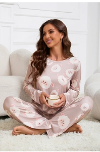 Detail of sweet pink pajama set with cute white sheep pattern on soft fabric