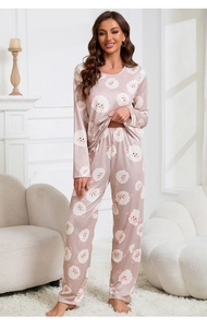 Full view of pink long-sleeved pajama set featuring white cartoon sheep prints on a model