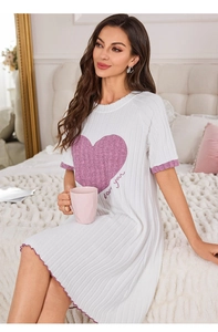 Close-up of white ribbed nightdress featuring purple heart print and ruffled edge detail