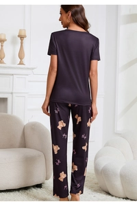 Detail of cute bear printed loose pajama pants and soft fabric texture on a model