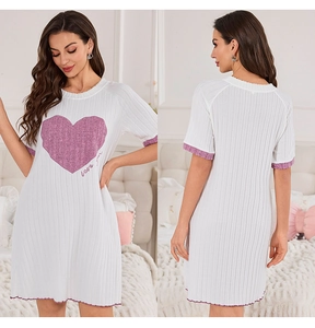 Detail of white knit nightdress with pink heart print and ruffled lettuce hem