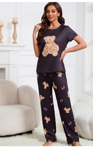 Cozy two-piece purple pajama set featuring adorable bear prints in a home setting