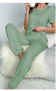 Close-up of light green short-sleeved pajamas and drawstring joggers in soft fabric