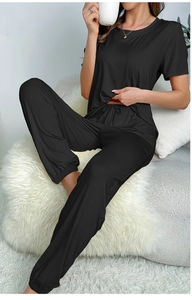 Detail of black short sleeve loungewear set with drawstring waistband on soft plush rug