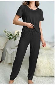 Detail of black pajama set featuring elastic drawstring waist and cuffed hem joggers