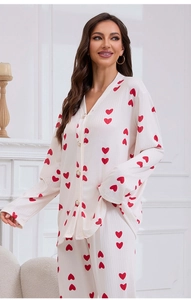 Close-up of heart print pajamas with elegant pearl buttons and ribbed fabric texture