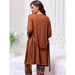 Women's three-piece lounge set with brown cardigan and printed pants in a cozy bedroom