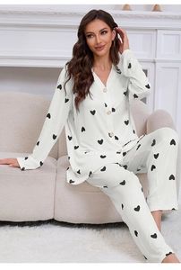 Detail of soft off-white loungewear set with black heart print and ribbed texture