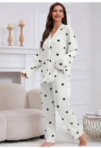 Close-up of women's cream loungewear set featuring a black heart print and buttoned top