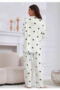 Rear view of white pajama set featuring black heart prints and fine ribbed knit texture