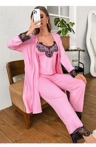 Detail of pink silk sleepwear with black floral lace on sleeves and trouser hems