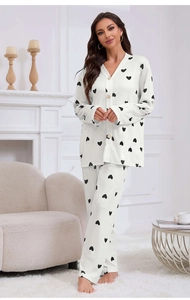 Detail of white two-piece pajama set with black heart print and button-down collar