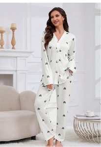 Detail of waffle knit pajama set with heart print and button-front top on a female model