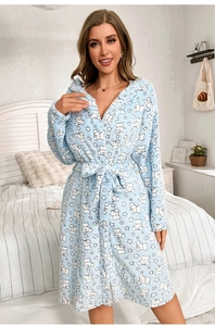 Detailed view of plush light blue winter robe with cute white bear and star patterns