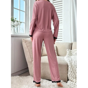 Pink long-sleeve pajama set with black lace trim and cozy knit ribbed texture