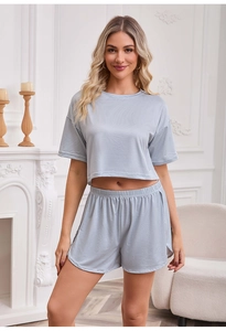 Detail of blue striped short-sleeve top and elastic shorts with side slits on model