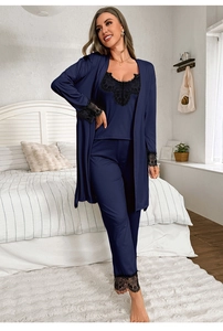 Detail of dark blue lace trim on silk satin pajamas set with floral embroidery