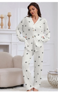 Detail of white pajamas with heart print featuring button-down top and ribbed knit texture