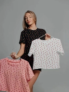 Detail of three-color women's heart print pajama tops with ruffled hem and crew neck