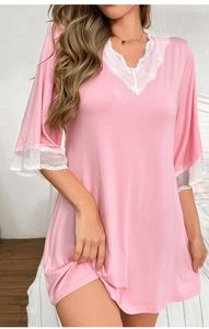 Close-up of pink modal nightdress featuring V-neckline and delicate white lace trim details