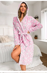 Detail of pink flannel bathrobe with white bear pattern, plush texture and tie-waist design