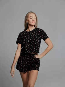 Close-up of black summer pajamas with red heart print and ruffled lettuce edge trim