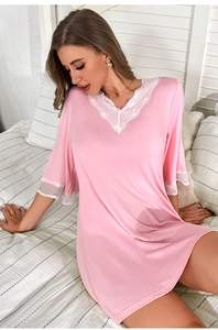 Close-up of pink modal nightgown featuring delicate white lace trim on the V-neckline