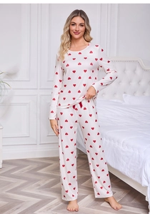 Close-up of heart print pajama set with a red bow detail on the elastic waistband
