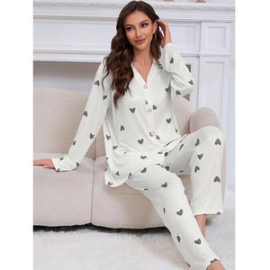Two-piece white pajama set with grey heart print featuring button-up V-neck and long pants